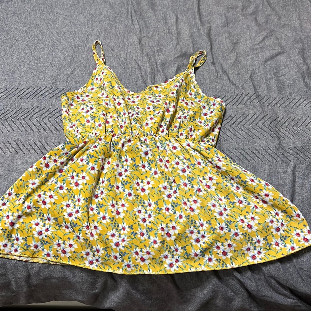 Yellow floral tank top. Super flattery with an A line style.